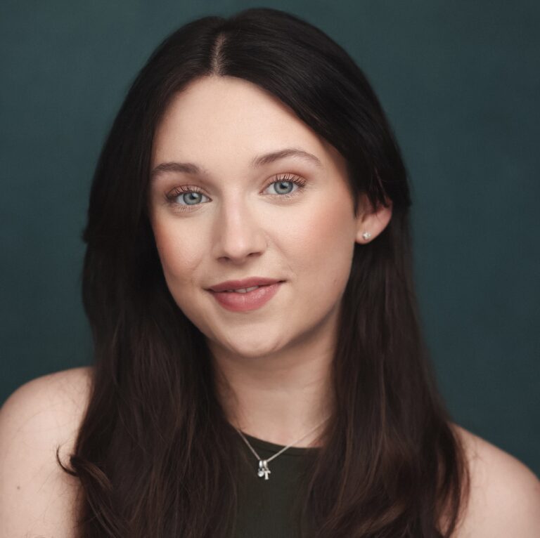 Headshot of Hannah Miller-Ellis, smiling.