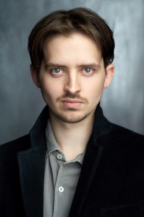 Headshot of James Penniston, in a dark jacket.