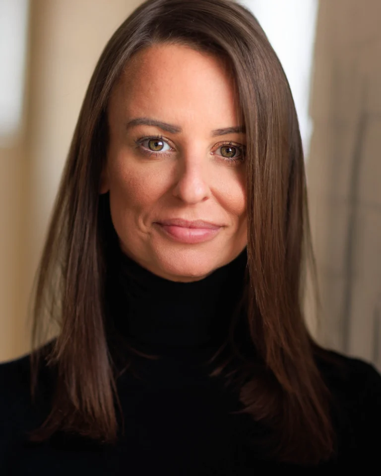 Headshot of Kelly-Marie Gibbs, in a black polo neck.